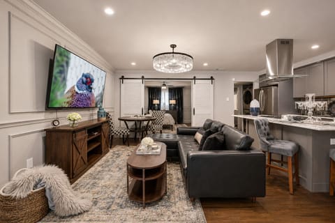 Relax on the comfy leather sectional  offering great views of the 65'' smart TV—perfect for catching up on your favorite shows.