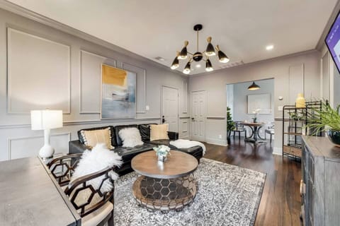 Living room with comfy sectional, Roku, Smart TV and dedicated workspace.