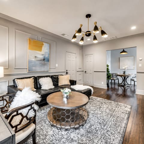 Living room with comfy sectional, Roku, Smart TV and dedicated workspace.