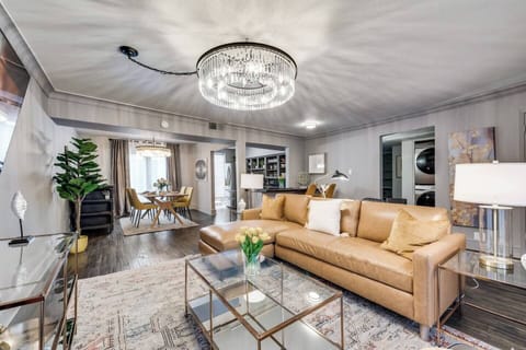 Spacious living room with a roomy leather sectional and plenty of seating, plus a large Smart TV for ultimate relaxation and entertainment.