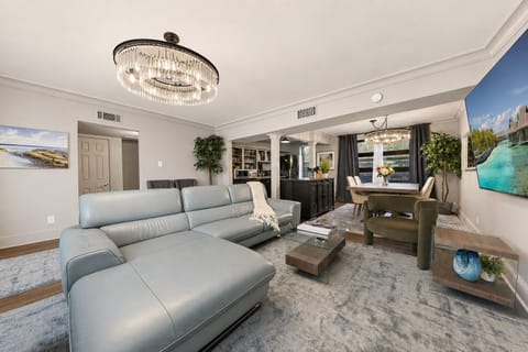 Relax in this spacious open floor plan with an over sized sofa and 65 smart tv.