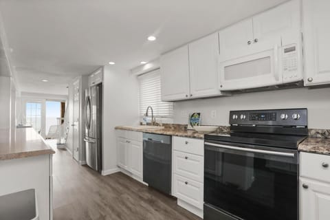 full kitchen with stove, microwave, dishwasher and full size refridgerator