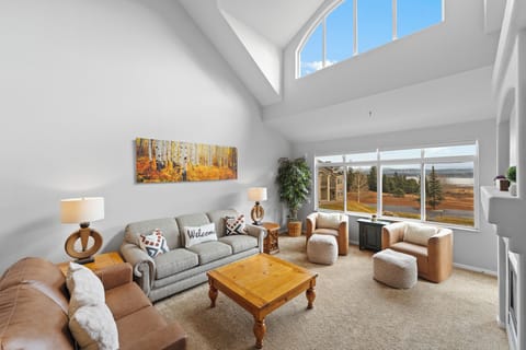 Sink into plush seating while natural light floods your spacious living room through soaring skylights and panoramic windows.