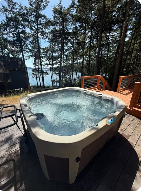 Private hot tub on expansive deck and water views. 