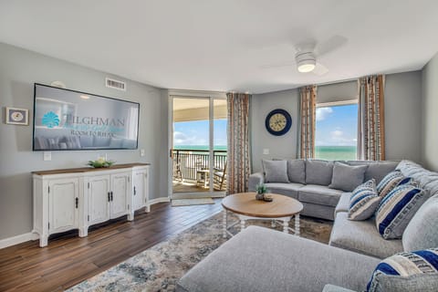 Sink into plush sectional seating while ocean breezes flow through your private balcony doors, creating the perfect coastal retreat.