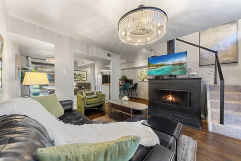 Living room with a 65 inch TV and with a French patio door . 