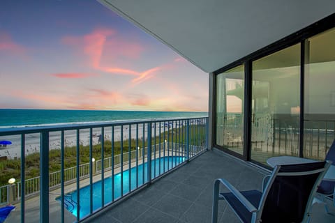 Watch stunning sunsets paint the sky from your private balcony, with the ocean and pool creating a perfect backdrop.