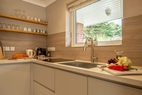 Ground floor: Kitchen with electric oven and hob, microwave, dishwasher, fridge-freezer, and washing machine