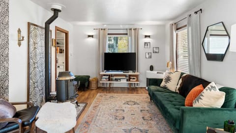 Warm up by the fire in this inviting living room. There is an Amazon Fire TV with many network apps to use. 