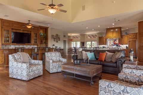 Wet bar and living room with 55" TV in bar as well as a 80" TV in living room