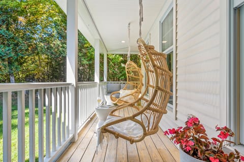 Relax and "hang out" on the covered front porch. Two hanging chairs and sofa