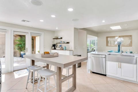 The kitchen is a spacious area with a large center island. The appliances are seamlessly integrated, giving it a sleek modern look.