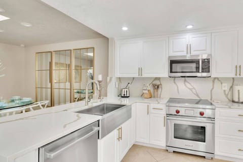 The kitchen boasts a sleek and modern design. Perfect place for cooking your favorite dish!
