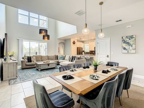 Bright and airy living space with high ceilings and a fully equipped kitchen.