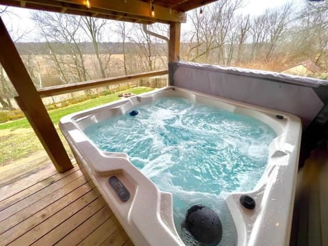 6 person Hot Tub that is available all year round. Hot tub is covered and near the back patio door. 