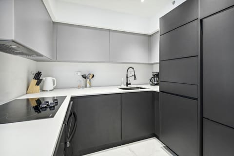 modern kitchen with fridge, washer/dryer, microwave, oven and stove
