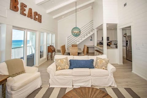 - Unwind in this coastal chic space featuring plush seating and beautiful beach views - Sunlight pours through the wall of windows, setting the scene for a dreamy escape - Vaulted ceilings, open design, and ocean breezes create the ultimate vibe