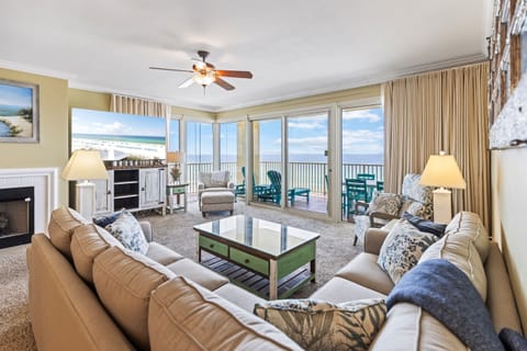 Sink into plush sofas while floor-to-ceiling windows frame endless ocean views, creating your perfect beachfront sanctuary for relaxation.