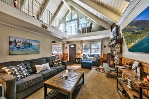 You'll love unwinding in this spacious living room with soaring ceilings, cozy fireplace, and comfortable seating perfect for gathering with loved ones.