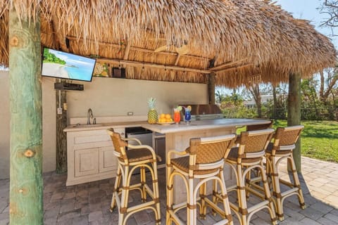 Sip on a cocktail at the tiki bar while catching your favorite sports game—your ultimate relaxation spot awaits!