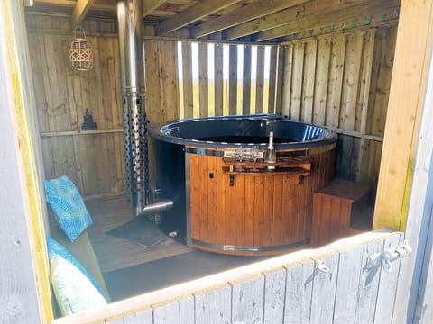 Wood-burning hot-tub under cover=comfortable for use during inclement weather