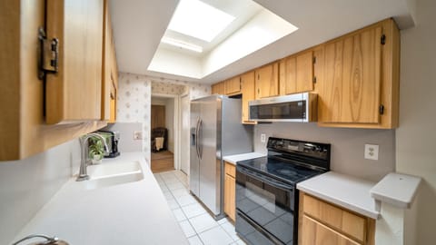 Easy meal prepping and cooking in this Gally Kitchen w/ a new fridge & microwave