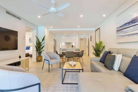 The open-plan living and dining area has been tastefully styled with calm, coastal furnishings. Central cooling and ceiling fans throughout keep temperatures comfortable. 