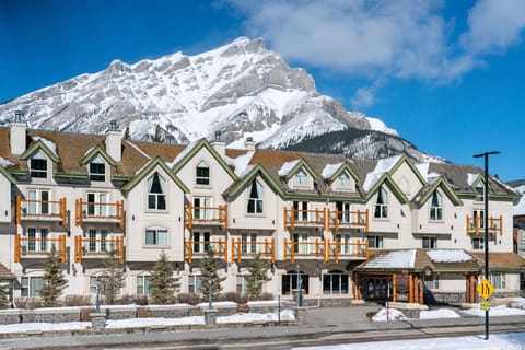 Snow blankets the rooftops and surrounding peaks on a clear winter day