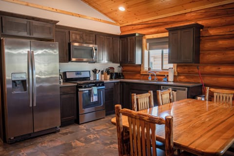 Full kitchen with stove, oven, refrigerator, freezer, dishwasher, dishes