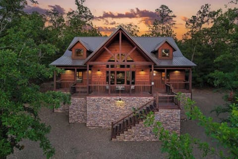 Your perfect getaway starts at Our Happy Place Cabin. Nestled on a private 1-acre lot surrounded by trees, featuring 3 king suites, relaxing hot tub, cozy fire pit, and a playground for kids. Stay with us and enjoy complimentary wine & s'mores!