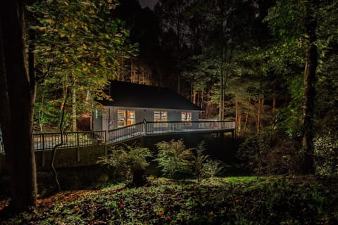 Pull up to your own cabin glowing in the trees at dusk — decks lit, woods quiet, your Smoky Mountain weekend officially begun.