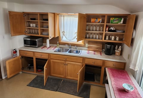 Fully stocked kitchen w/new dishes, pots/pans, coffee cups, coffee, & creamer.