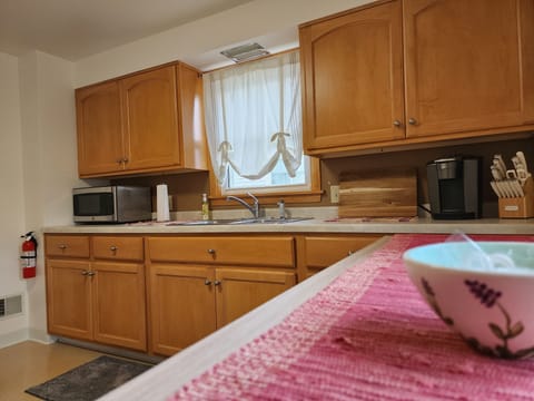 Bight and sunny w/ High top kitchen table with 2 bar stools with backyard views