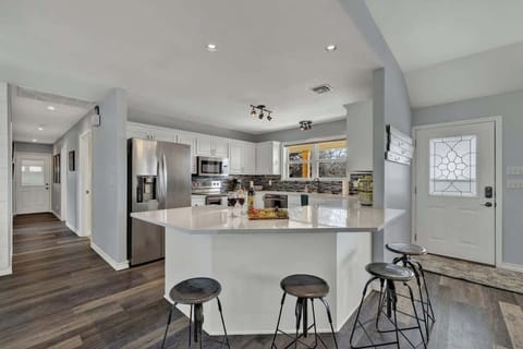 Full kitchen with bar seating for four.