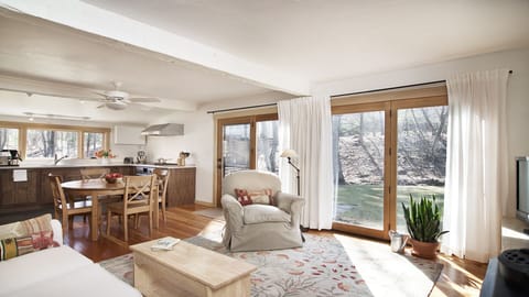 ...overlooking the stone patio, year-round stream + wooded conservation land.