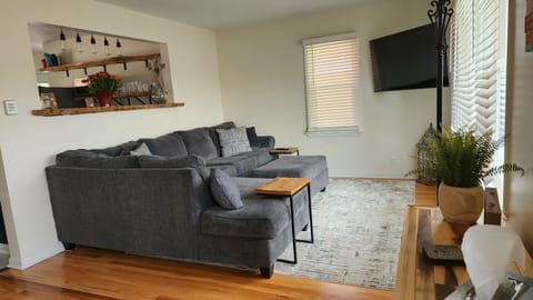 Living Room With Sectional and TV, plenty of light in this home!