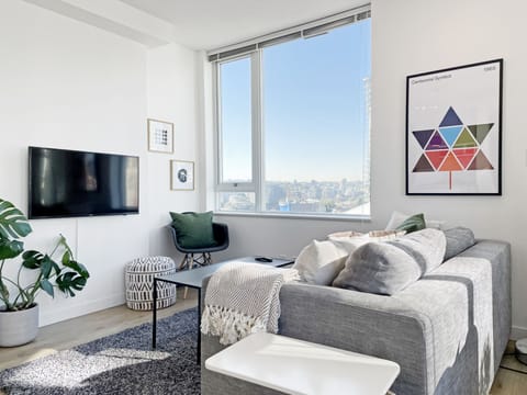 The living room is equipped with a Samsung 50-inch 4k smart TV and sofa bed.