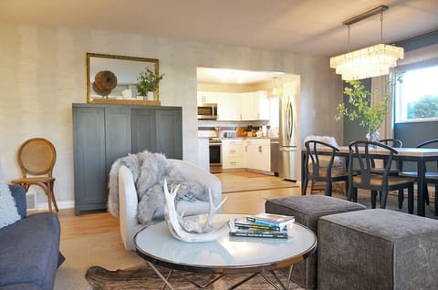 Main level open concept living room with TV, 6 person dining set and fully stocked kitchen area. Perfect for entertaining.