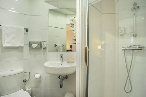 Shower, hair dryer, slippers, towels