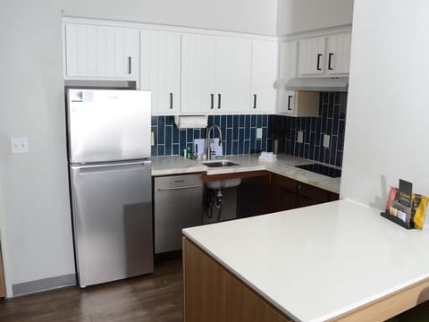 Fully-equipped kitchen with sleek cabinetry perfect for in-room meals.
