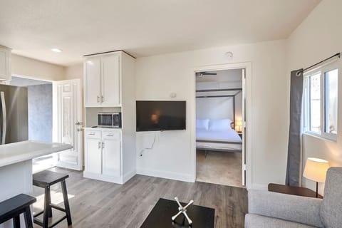 Open space, living room & kitchen with 50" TV and Roku.