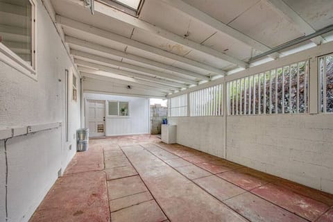 The driveway is on the right side of the property and there is a carport with a garage door for 1 covered parking spot.