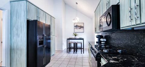 Fully stocked kitchen with flatware and essential appliances