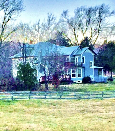 Back of our remodeled farm home, fenced pastures on all sides. 