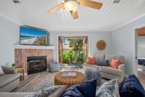 Relax in this charming coastal living area with French doors, a smart TV, and a pull-out sofa—perfect for 2 guests seeking comfort and style.