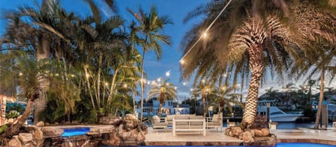Waterfront Resort Style Oasis with Salt Water Heated Pool, Spa, Tiki Hut & Bar, Outdoor Kitchen, Outdoor Dining Area, 80' Deep Water Dock / Floating Dock with no fixed bridges to Intercoastal.  Plenty of Seating Areas, a Hammock & much mor