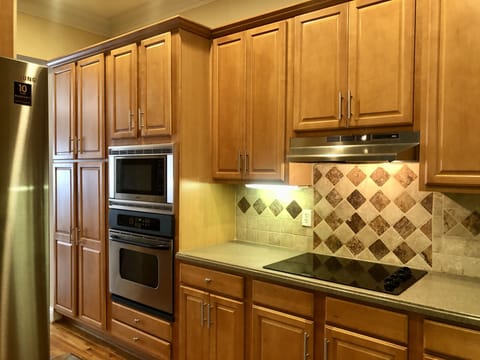 Kitchen with microwave, stove and electrical cooktop