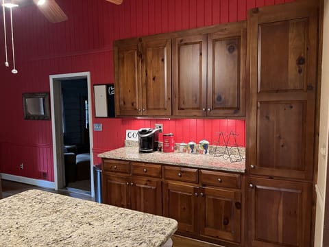 Kitchen features additional cabinets and coffee station