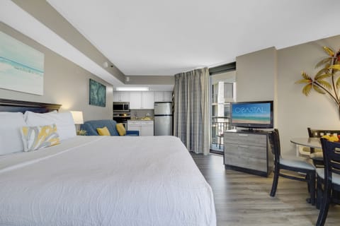 This unit boasts a generous 1 King-size bed, complemented by expansive sliding doors that open up to a roomy balcony with a serene view of the ocean.
