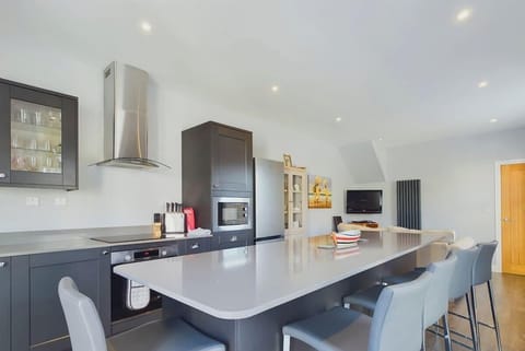 The heart of the home: a modern open-plan kitchen and sitting area, perfect for socialising while cooking.